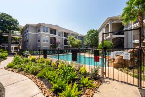 Apartments in Houston, TX - Entrance Gate to Pool with Apartment Buildings in Background