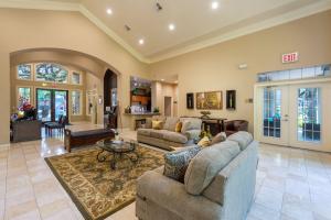 Apartments For Rent in Houston, Texas - Clubhouse Interior Seating Area with Couches and View of Lobby and Leasing Areas