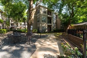 Apartments For Rent in Houston, TX - Outdoor Grilling Area with Benches by Dog Park