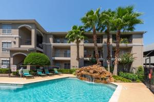 Apartments For Rent in Houston, Texas - Pool with Rock Fountain and Patio with Lounge Chairs